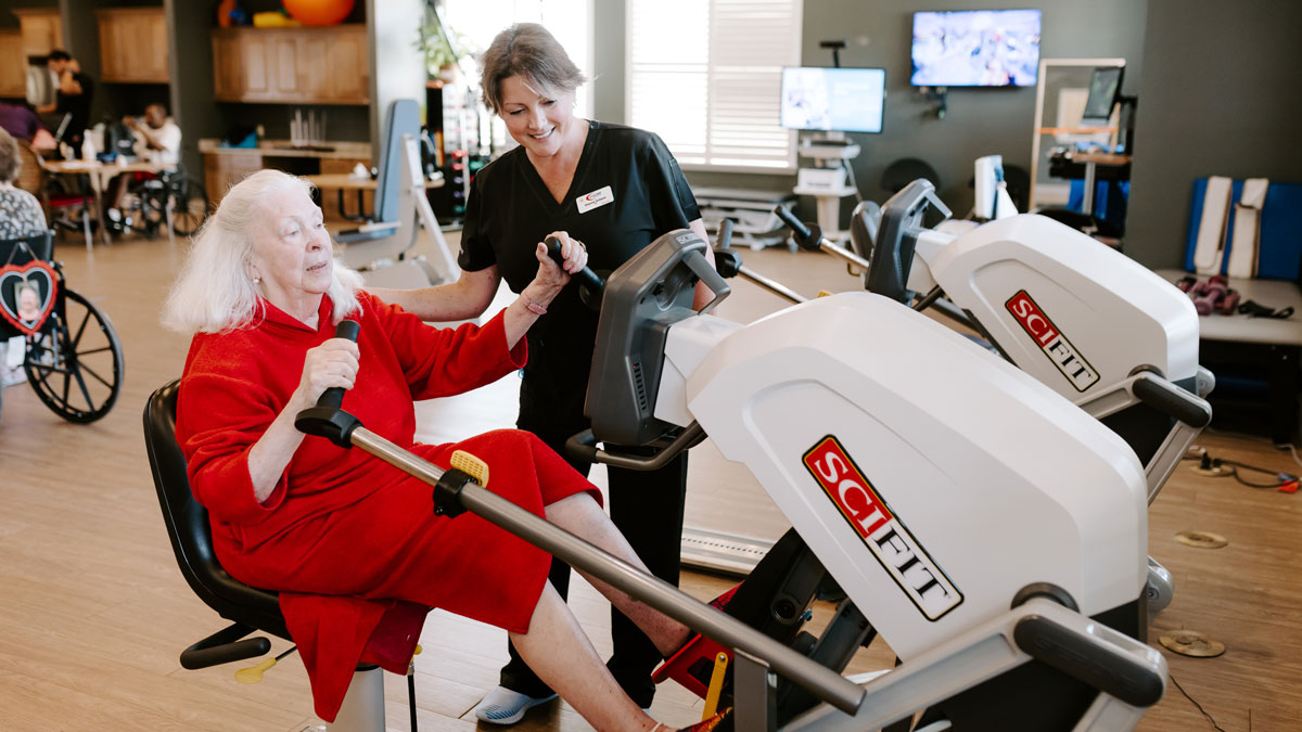 ProCare Therapist Assisting Woman working out on machine